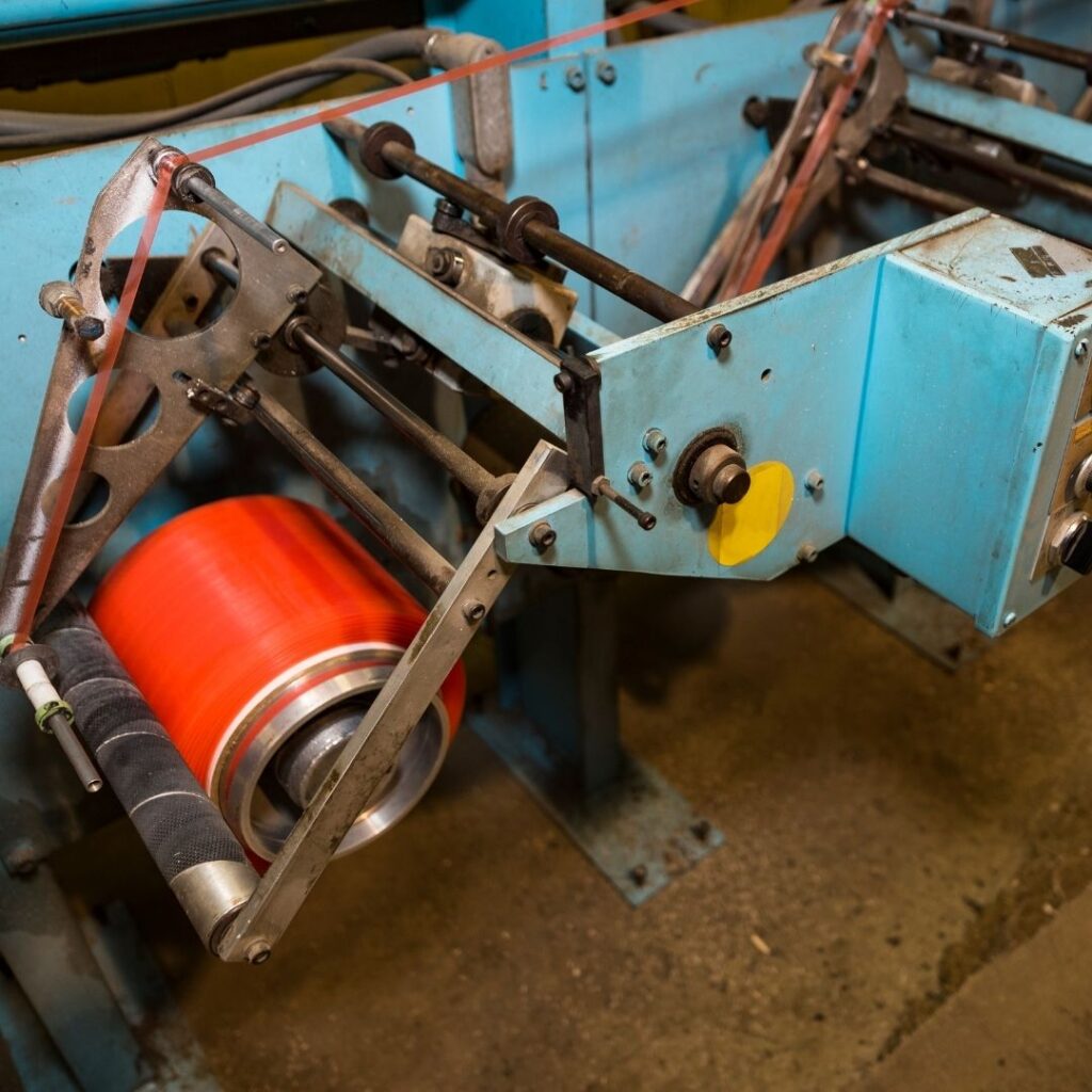 a machine with a large red tape spool